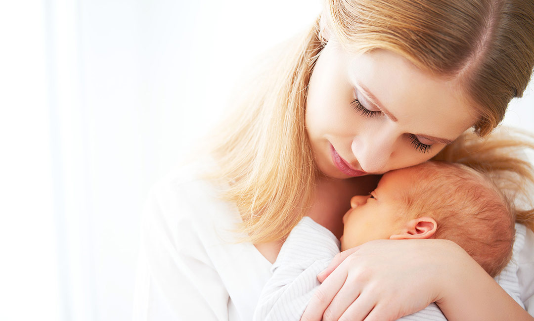 50758244-newborn-baby-in-a-tender-embrace-of-mother-at-the-window
